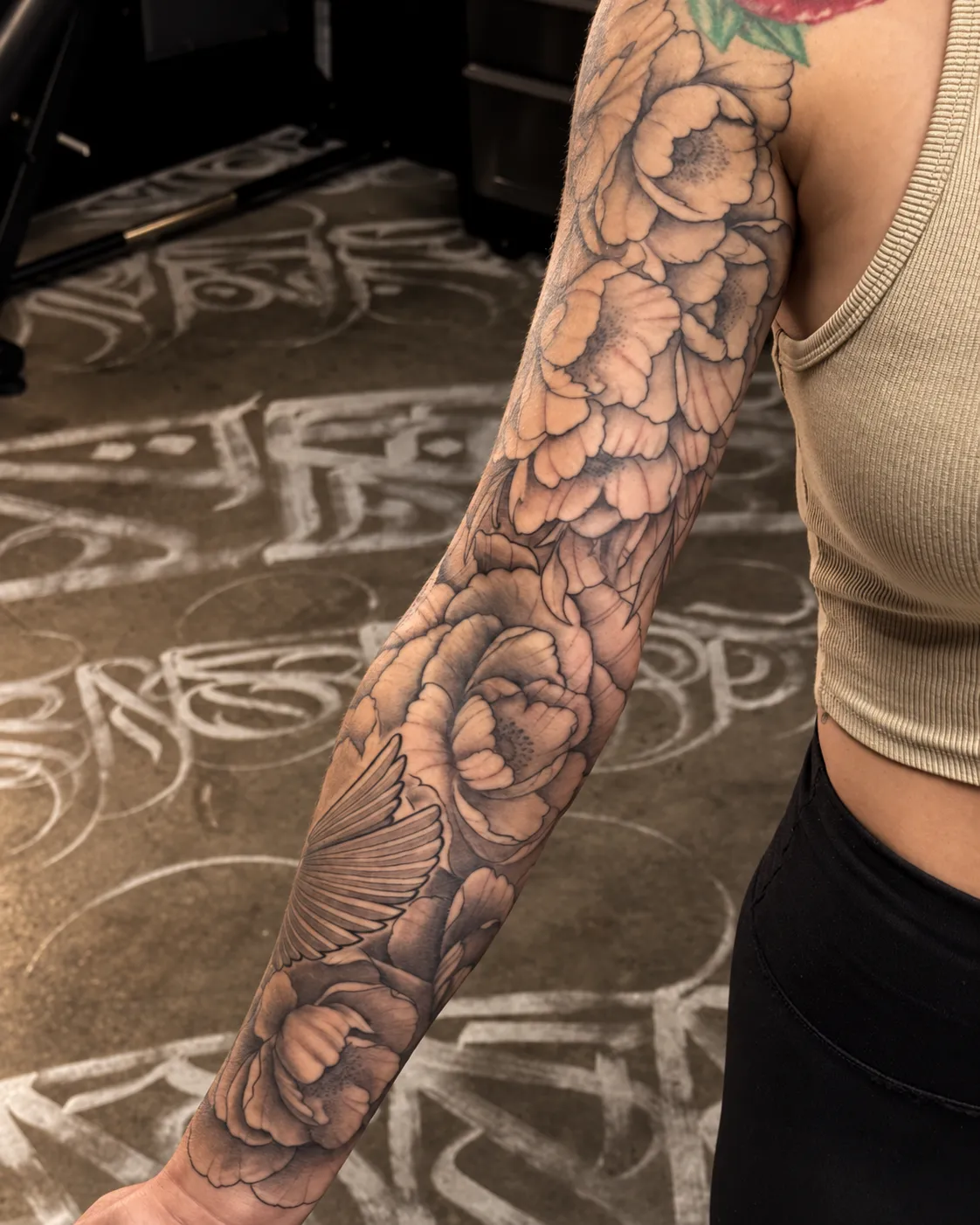 Large black and grey floral sleeve following the arm