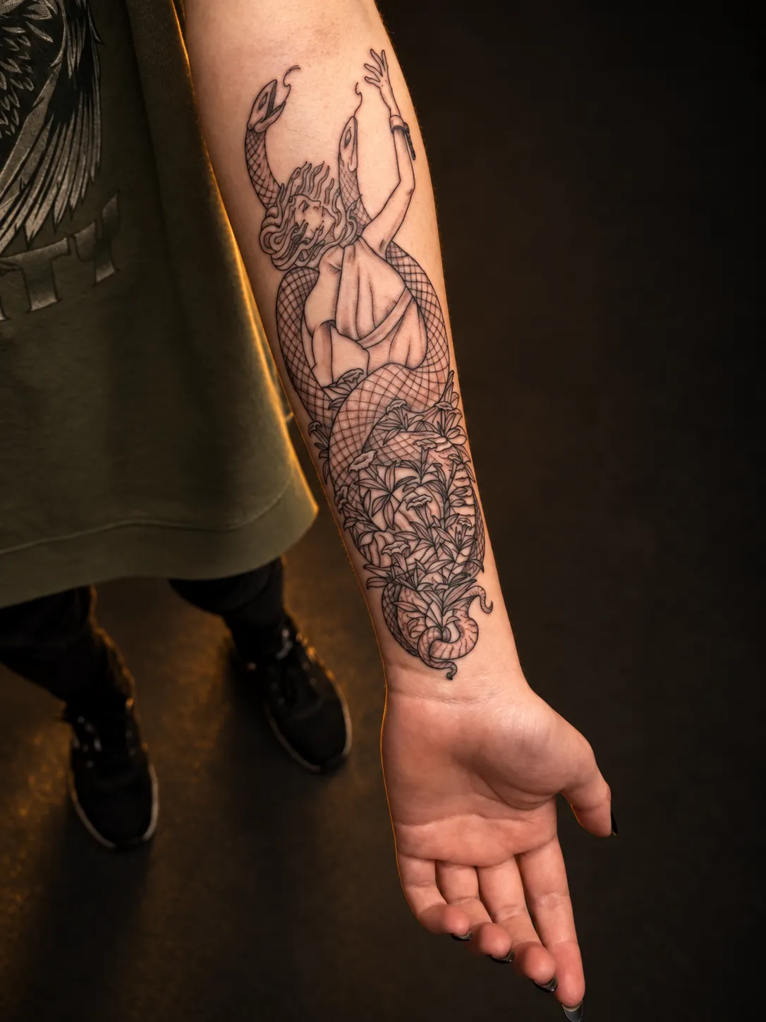 Black and grey Medusa tattoo on the forearm